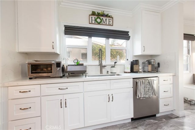 kitchen with white cabinets, dishwasher, ornamental molding, and sink