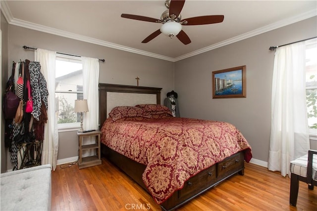 bedroom featuring ceiling fan, crown molding, and light wood-type flooring