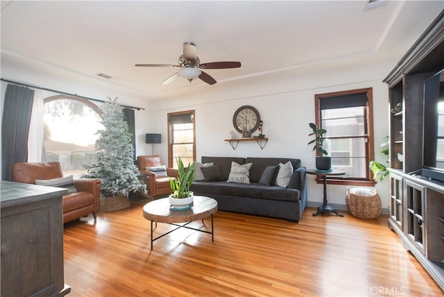 living room with ceiling fan and light hardwood / wood-style flooring