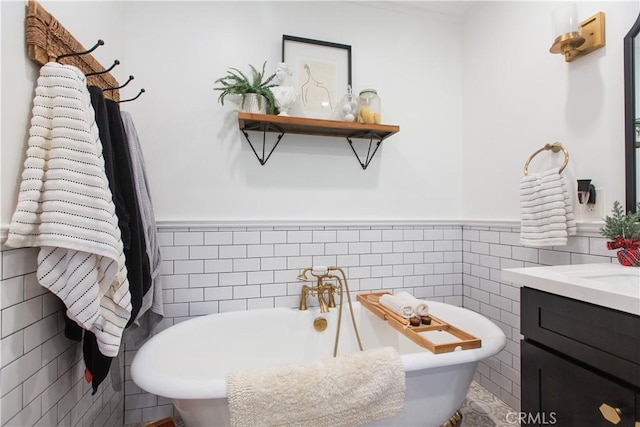 bathroom with a washtub, tile walls, and vanity