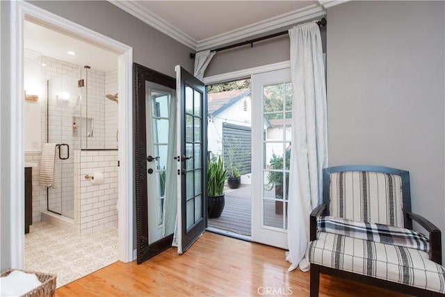 doorway featuring light wood-type flooring and ornamental molding