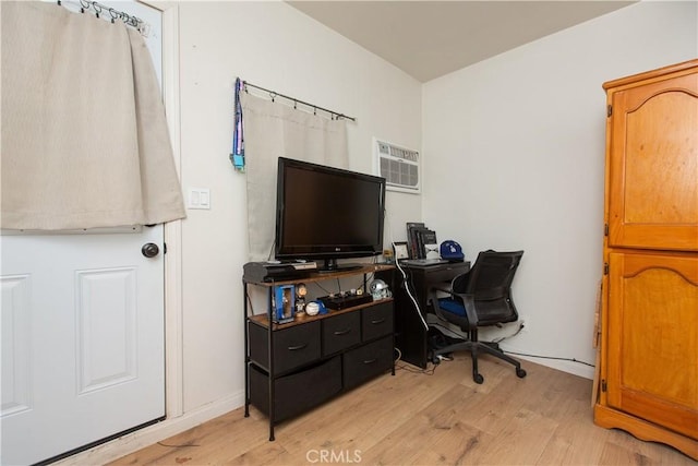 office featuring a wall mounted air conditioner and light wood-type flooring