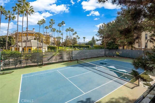 view of tennis court featuring basketball hoop