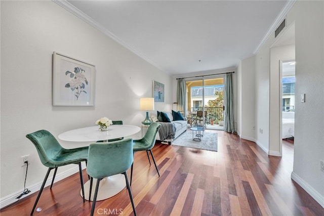 dining room featuring hardwood / wood-style floors and ornamental molding