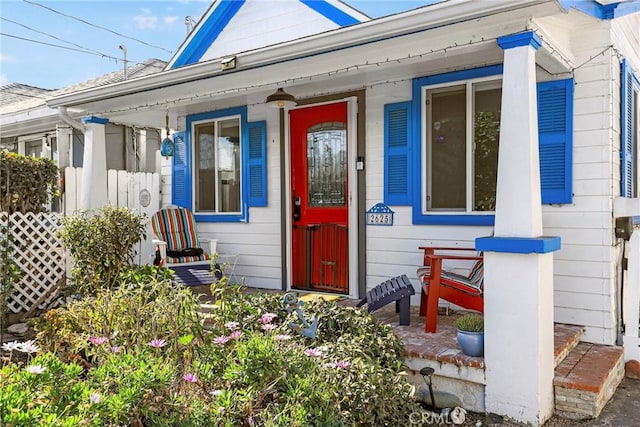 view of exterior entry with a porch