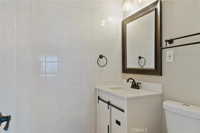 bathroom featuring toilet and vanity