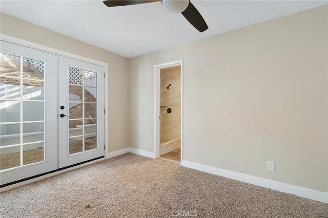 empty room with ceiling fan, carpet, and french doors