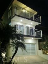 view of front of house with a balcony and a garage