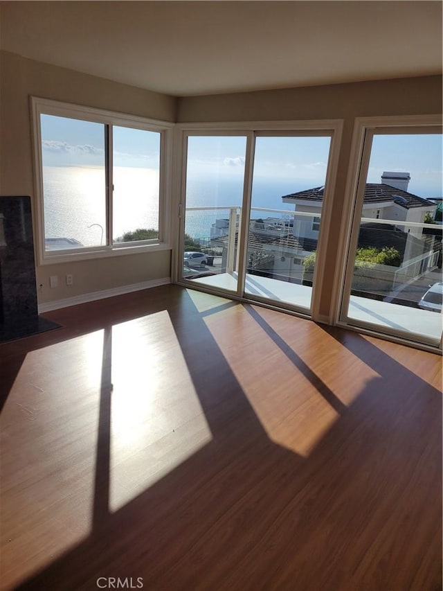 interior space with wood finished floors and baseboards