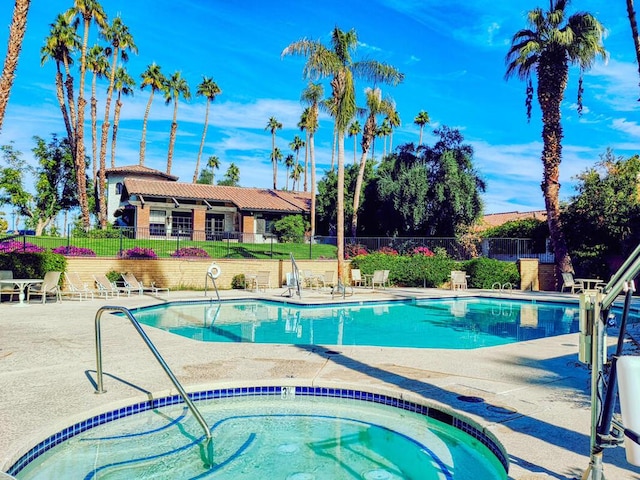 view of pool with a community hot tub and a patio