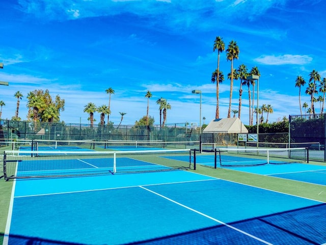 view of tennis court featuring basketball hoop