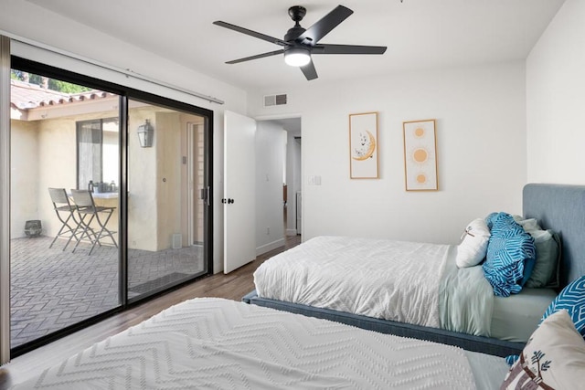 bedroom with access to exterior, hardwood / wood-style flooring, and ceiling fan