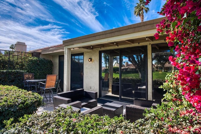 entrance to property with an outdoor hangout area