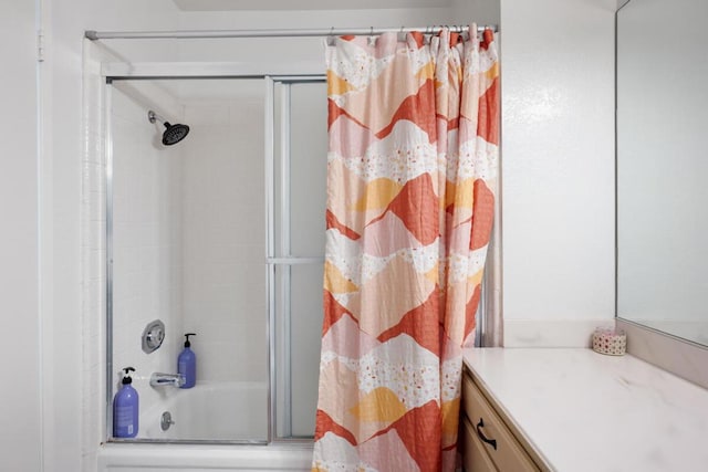 bathroom with vanity and tiled shower / bath combo