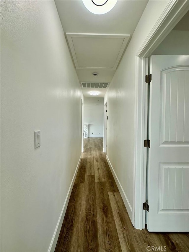 hallway with hardwood / wood-style floors