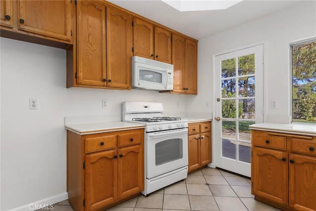 kitchen with white appliances and light tile patterned floors