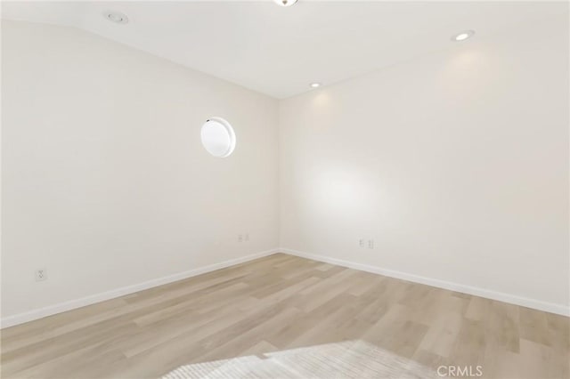 spare room with light hardwood / wood-style flooring