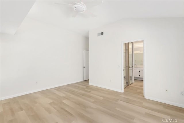 unfurnished bedroom with connected bathroom, ceiling fan, light hardwood / wood-style floors, and lofted ceiling