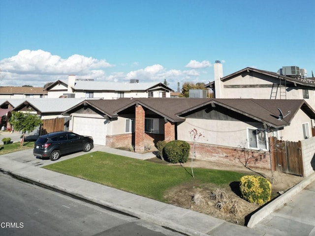 view of front of home featuring a front lawn, central AC unit, and a garage