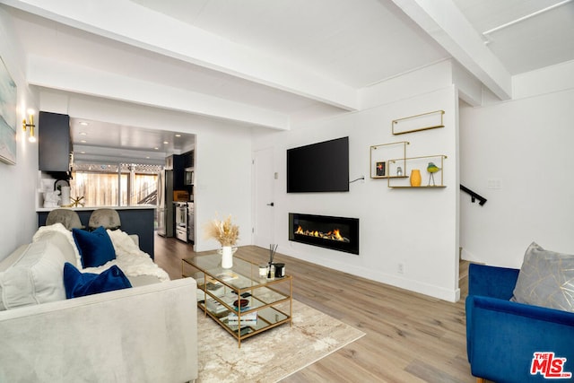 living room with hardwood / wood-style flooring and beamed ceiling