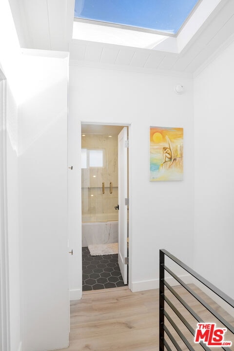 hallway with hardwood / wood-style flooring