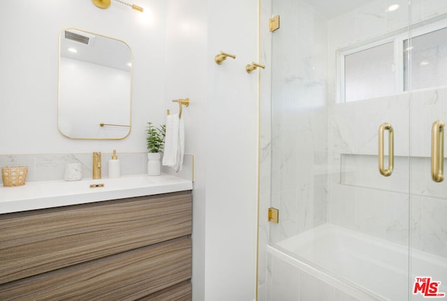 bathroom with walk in shower and vanity