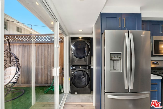 laundry room with stacked washing maching and dryer