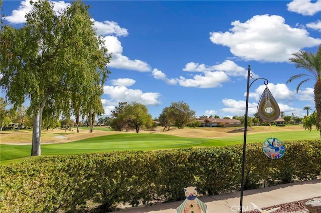 view of home's community featuring a yard and golf course view