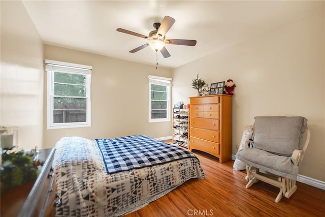 bedroom with hardwood / wood-style floors and ceiling fan