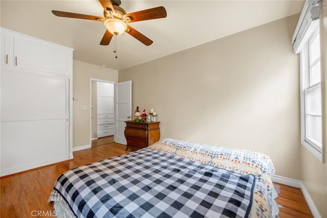 bedroom with ceiling fan and light hardwood / wood-style flooring