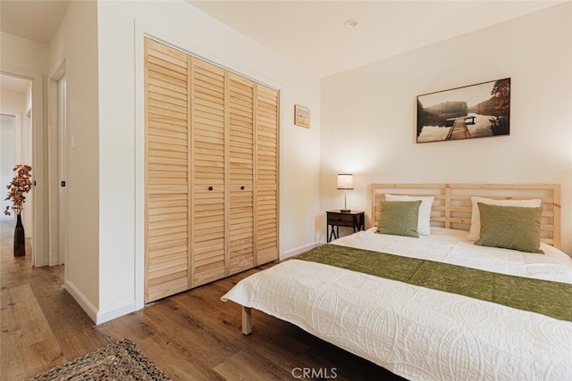 bedroom with a closet and hardwood / wood-style flooring