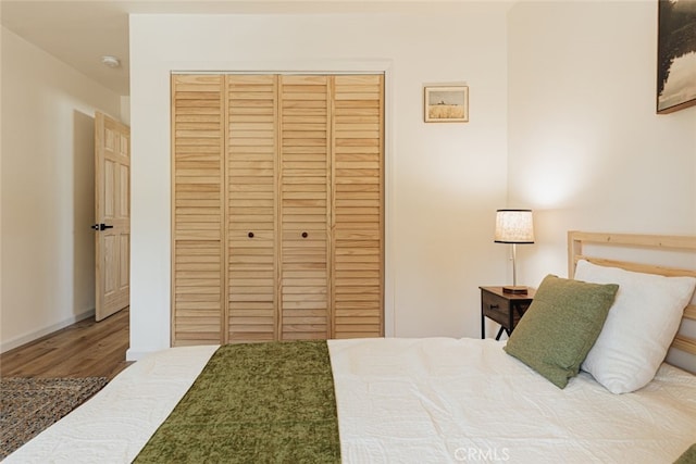 bedroom featuring hardwood / wood-style flooring and a closet