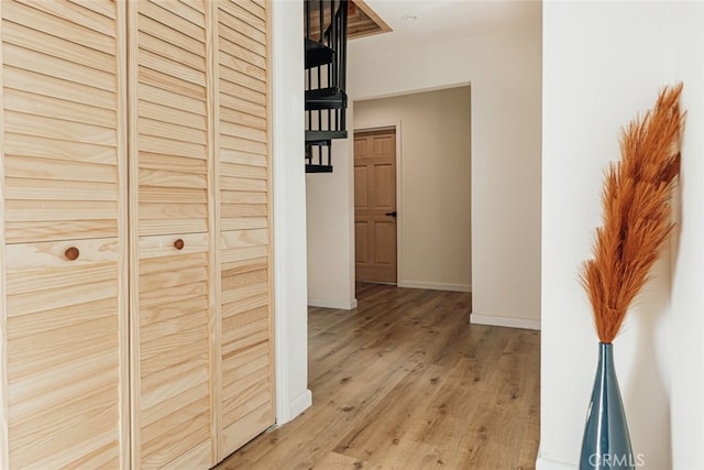 hallway with hardwood / wood-style flooring