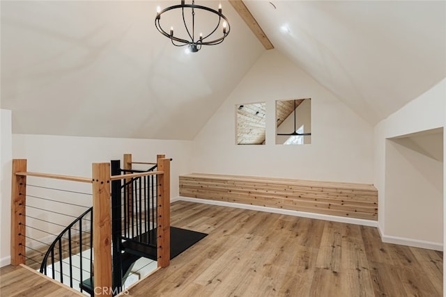 additional living space with lofted ceiling with beams, light hardwood / wood-style floors, and a notable chandelier