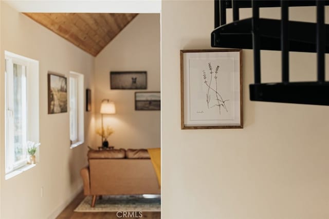 hallway with lofted ceiling and wooden ceiling