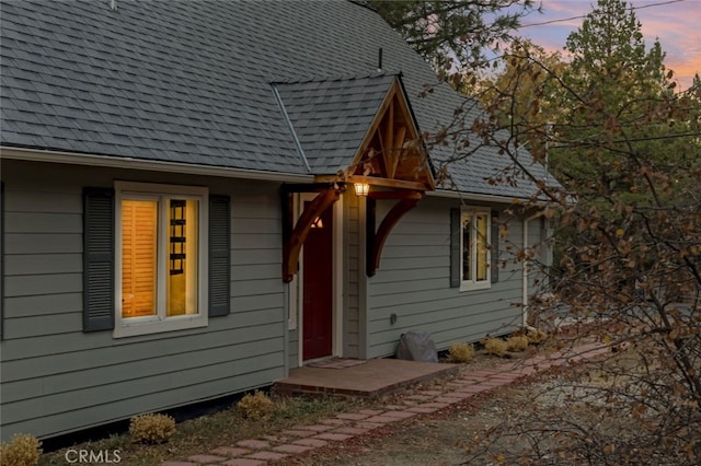 view of back house at dusk