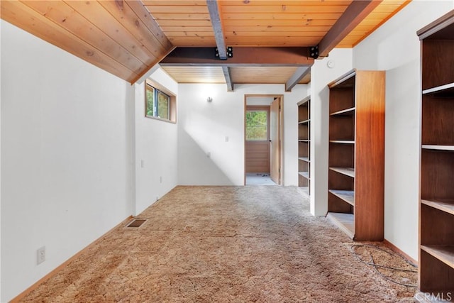 carpeted spare room with beam ceiling, a wealth of natural light, and wooden ceiling