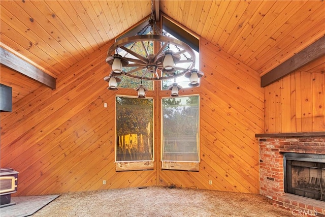 unfurnished living room featuring carpet flooring, lofted ceiling with beams, and wood walls