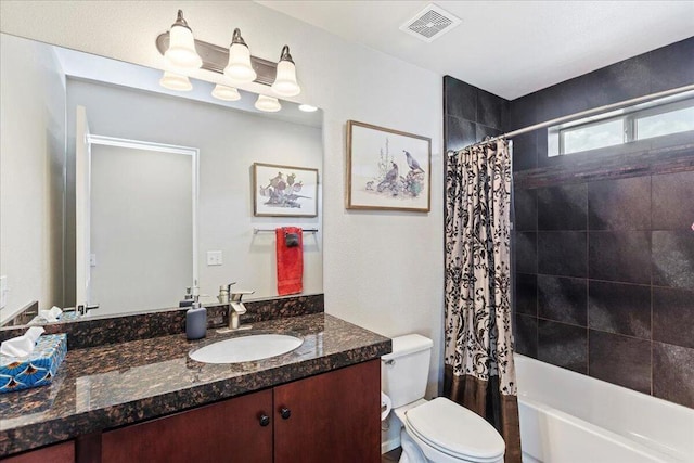 full bathroom featuring shower / tub combo, vanity, and toilet