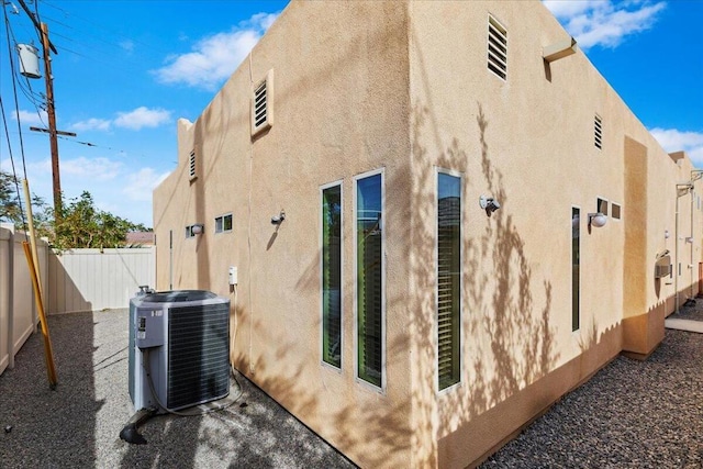 view of side of home featuring central AC