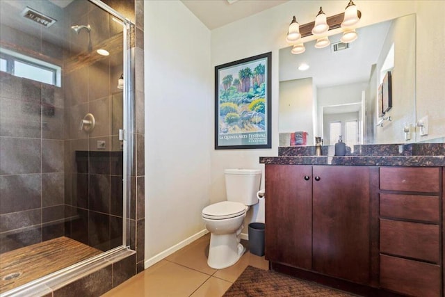 bathroom with tile patterned floors, vanity, toilet, and a shower with shower door