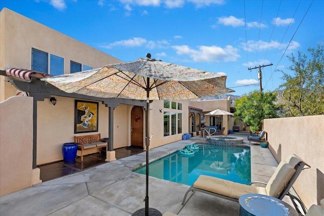 view of swimming pool with a patio area and an in ground hot tub