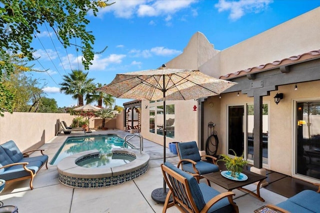 view of swimming pool featuring an in ground hot tub and a patio