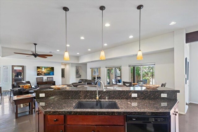 kitchen featuring ceiling fan, sink, hanging light fixtures, black dishwasher, and an island with sink