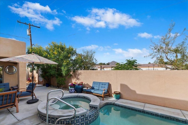 view of swimming pool featuring a patio area and an in ground hot tub