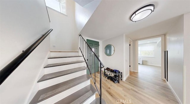 stairway featuring wood-type flooring