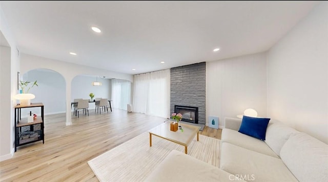 living room with a fireplace and light hardwood / wood-style flooring