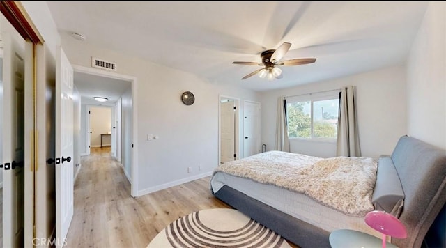 bedroom with a closet, light hardwood / wood-style flooring, and ceiling fan