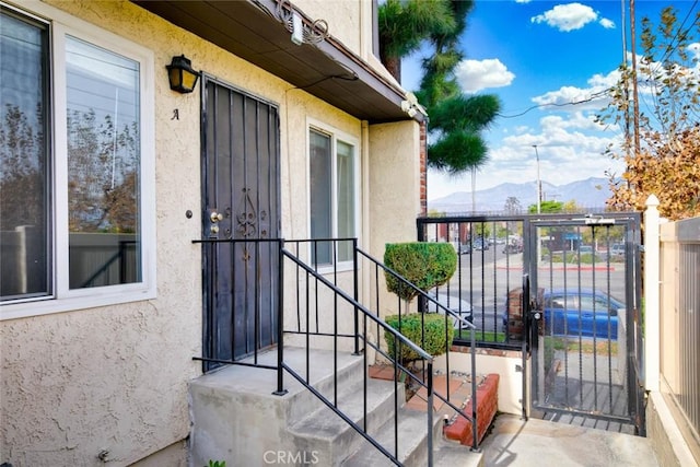 view of exterior entry with a mountain view