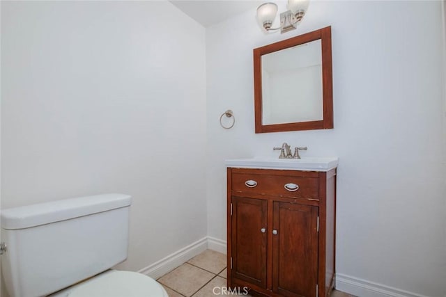 bathroom featuring tile patterned flooring, vanity, and toilet